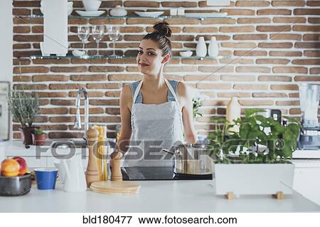 Caucasian woman cooking in kitchen View Large Photo Image Stock Photo - Caucasian woman cooking in kitchen. Fotosearch
