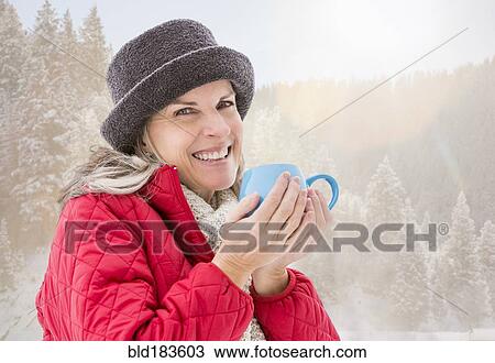Caucasian woman drinking coffee in snow View Large Photo Image Stock Image - Caucasian woman drinking coffee in snow. Fotosearch