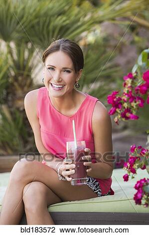 Caucasian woman drinking juice outdoors View Large Photo Image Stock Image - Caucasian woman drinking juice outdoors. Fotosearch