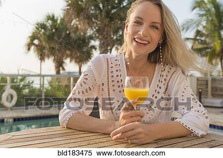 Caucasian woman drinking orange juice View Large Photo Image Stock Photography - Caucasian woman drinking orange juice. Fotosearch