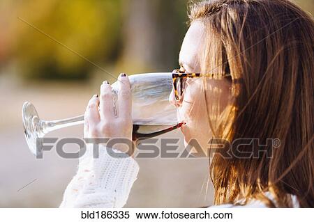 Caucasian woman drinking wine outdoors View Large Photo Image Stock Photography - Caucasian woman drinking wine outdoors. Fotosearch