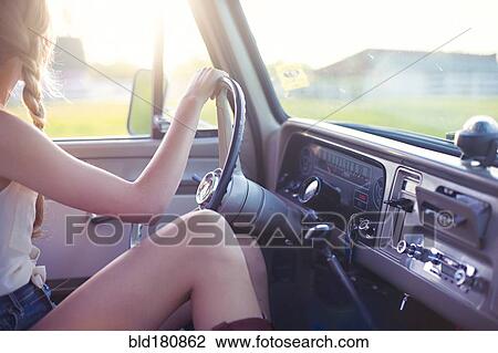 Stock Image - Caucasian woman driving car. Fotosearch