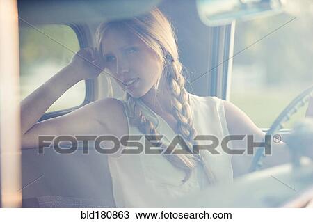 Stock Image - Caucasian woman driving car. Fotosearch