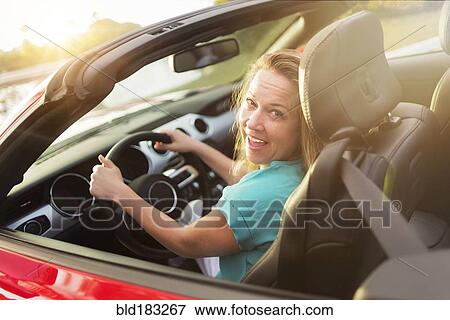 Stock Photo - Caucasian woman driving convertible. Fotosearch