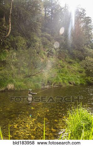 Caucasian woman fishing in remote river View Large Photo Image Stock Photo - Caucasian woman fishing in remote river. Fotosearch