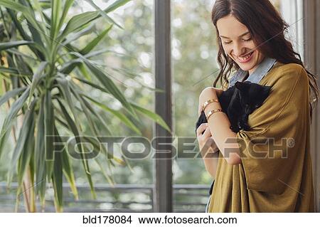 Picture - Caucasian woman holding kitten. Fotosearch