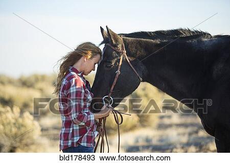 Caucasian woman hugging horse in field View Large Photo Image Stock Image - Caucasian woman hugging horse in field. Fotosearch