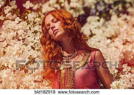 Stock Photo - Caucasian woman in flowering tree. Fotosearch