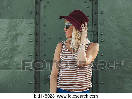 Stock Photo - Caucasian woman in hat and sunglasses. Fotosearch