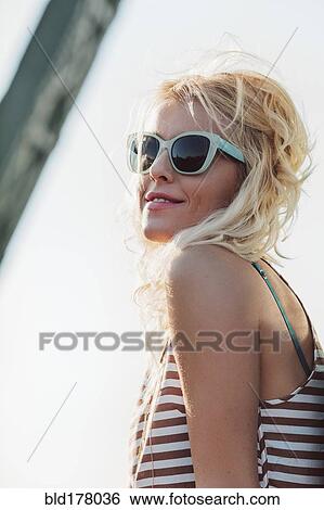 Stock Photograph - Caucasian woman in sunglasses outdoors. Fotosearch