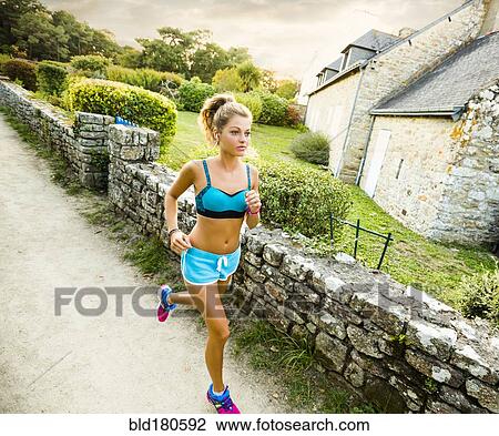Caucasian woman jogging outdoors View Large Photo Image Stock Image - Caucasian woman jogging outdoors. Fotosearch