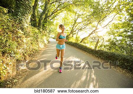 Stock Photo - Caucasian woman jogging outdoors. Fotosearch