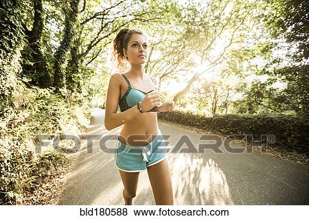 Stock Photo - Caucasian woman jogging outdoors. Fotosearch