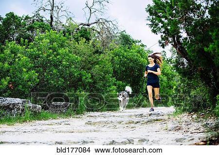 Caucasian woman jogging with dog View Large Photo Image Picture - Caucasian woman jogging with dog. Fotosearch
