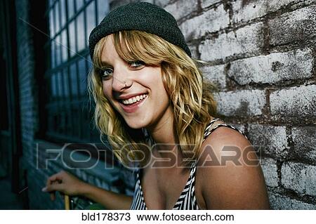 Stock Image - Caucasian woman laughing outdoors. Fotosearch