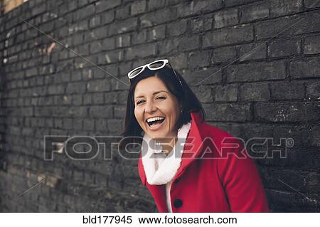 Stock Photography - Caucasian woman laughing outdoors. Fotosearch