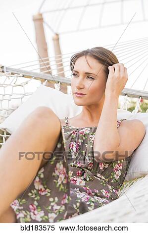 Stock Photography - Caucasian woman laying in hammock. Fotosearch