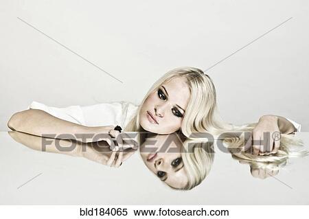 Caucasian woman leaning on reflective table View Large Photo Image Stock Photography - Caucasian woman leaning on reflective table. Fotosearch