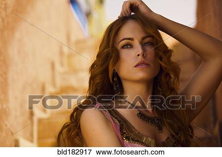 Stock Photo - Caucasian woman leaning on staircase wall. Fotosearch