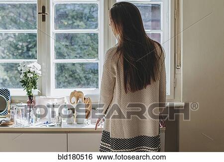 Caucasian woman looking out window View Large Photo Image Stock Photograph - Caucasian woman looking out window. Fotosearch