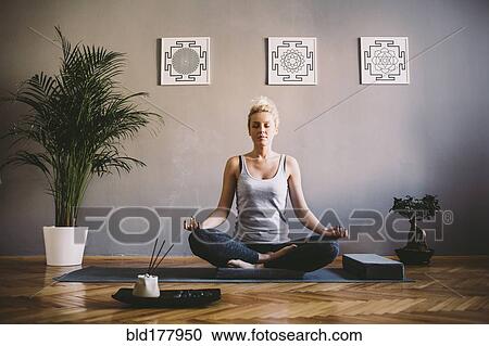 Caucasian woman meditating in yoga studio View Large Photo Image Stock Image - Caucasian woman meditating in yoga studio. Fotosearch
