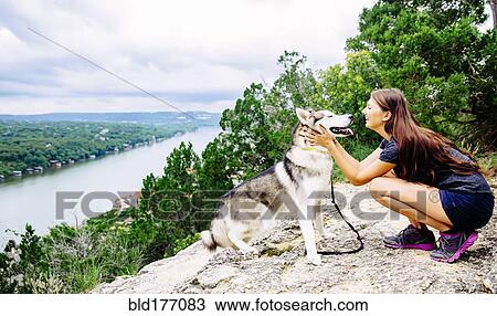 Caucasian woman petting dog outdoors View Large Photo Image Stock Image - Caucasian woman petting dog outdoors. Fotosearch