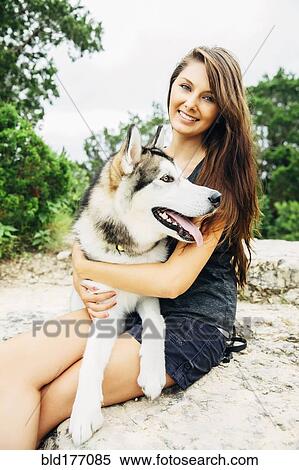 Caucasian woman petting dog outdoors View Large Photo Image Stock Photography - Caucasian woman petting dog outdoors. Fotosearch