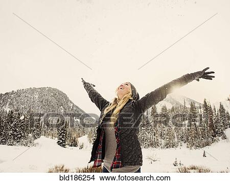 Picture - Caucasian woman playing in snow. Fotosearch