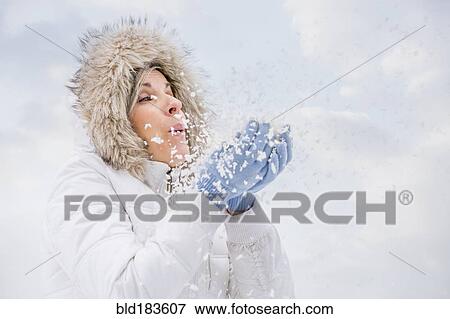 Stock Photo - Caucasian woman playing in snow. Fotosearch