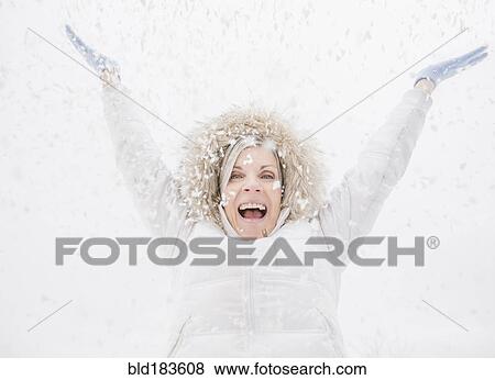 Stock Photo - Caucasian woman playing in snow. Fotosearch