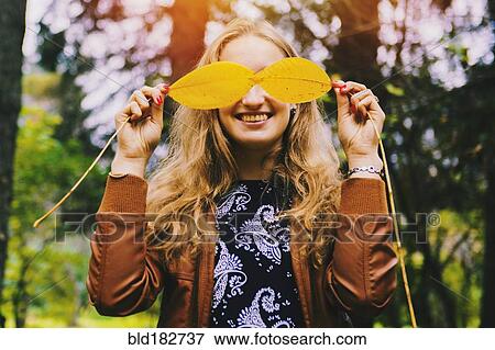 Caucasian woman playing with autumn leaves View Large Photo Image Stock Photo - Caucasian woman playing with autumn leaves. Fotosearch