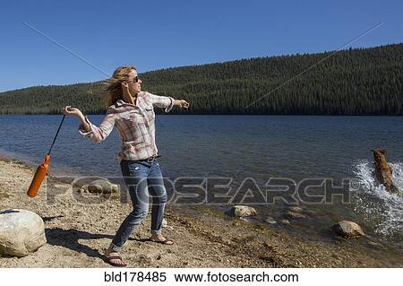 Caucasian woman playing with dog in river View Large Photo Image Stock Photography - Caucasian woman playing with dog in river. Fotosearch