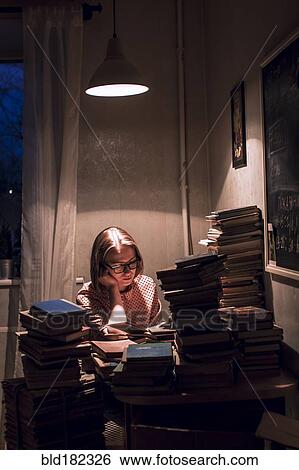Caucasian woman reading stack of books View Large Photo Image Stock Photograph - Caucasian woman reading stack of books. Fotosearch