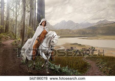 Stock Photo - Caucasian woman riding horse in remote forest. Fotosearch