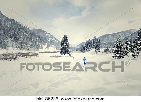 Caucasian woman running in snowy landscape View Large Photo Image Stock Photograph - Caucasian woman running in snowy landscape. Fotosearch