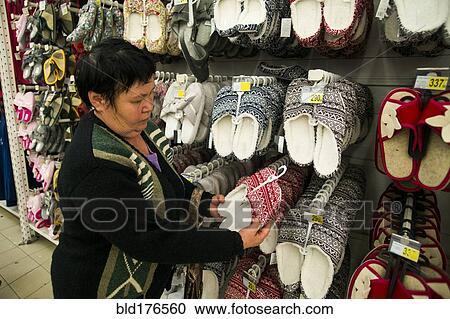 Stock Image - Caucasian woman shopping in store. Fotosearch