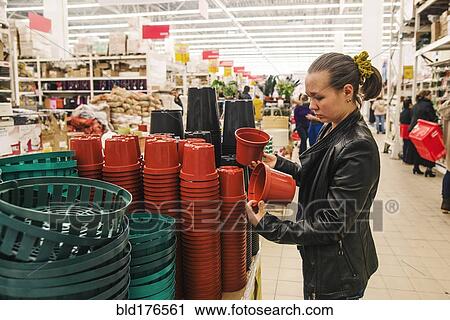 Stock Image - Caucasian woman shopping in store. Fotosearch