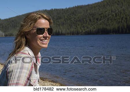 Caucasian woman sitting at remote river View Large Photo Image Stock Image - Caucasian woman sitting at remote river. Fotosearch