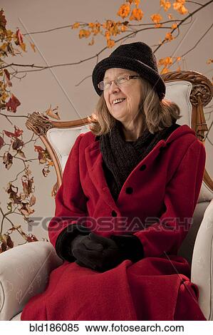 Caucasian woman sitting in armchair outdoors View Large Photo Image Stock Photography - Caucasian woman sitting in armchair outdoors. Fotosearch