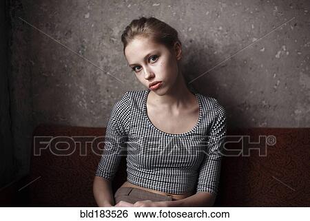Stock Photograph - Caucasian woman sitting indoors. Fotosearch
