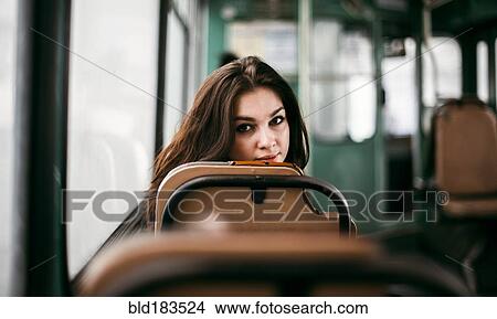 Picture - Caucasian woman sitting on bus. Fotosearch