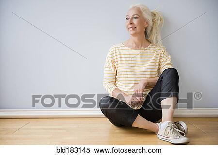 Caucasian woman sitting on floor View Large Photo Image Stock Photography - Caucasian woman sitting on floor. Fotosearch