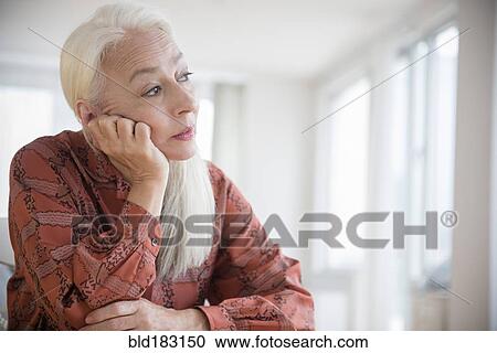 Caucasian woman sitting with chin in hand View Large Photo Image Stock Image - Caucasian woman sitting with chin in hand. Fotosearch