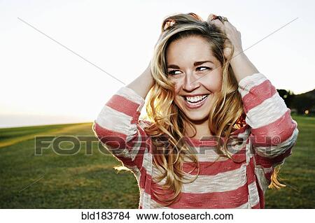 Caucasian woman smiling in field View Large Photo Image Picture - Caucasian woman smiling in field. Fotosearch