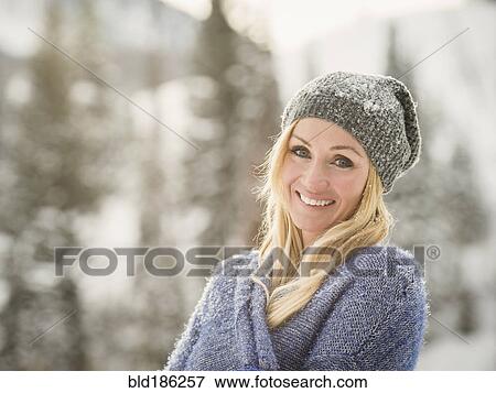 Caucasian woman smiling in snow View Large Photo Image Stock Photo - Caucasian woman smiling in snow. Fotosearch