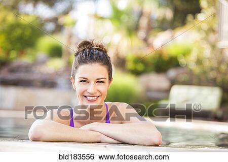 Caucasian woman smiling in swimming pool View Large Photo Image Stock Photograph - Caucasian woman smiling in swimming pool. Fotosearch