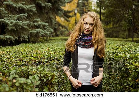Caucasian woman standing in garden View Large Photo Image Stock Image - Caucasian woman standing in garden. Fotosearch