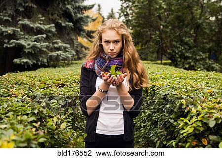 Stock Image - Caucasian woman standing in garden. Fotosearch