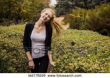 Caucasian woman standing in garden View Large Photo Image Stock Photo - Caucasian woman standing in garden. Fotosearch