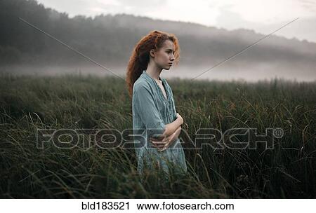 Caucasian woman standing in rural field View Large Photo Image Stock Image - Caucasian woman standing in rural field. Fotosearch